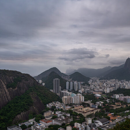 Views of the city and surrounding mountains from Sugarloaf Mountain, Pão de Açúcar in Rio De Janerio, Brazil on a cloudy night