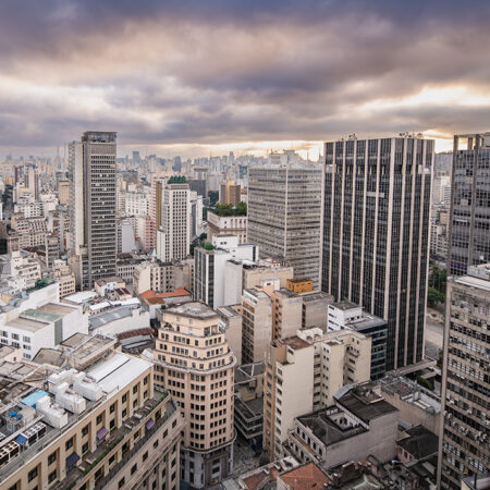 Views of the skyline of São Paulo, Brazil from the window from the Mirante do 26 observation deck at sunset on a cloudy day