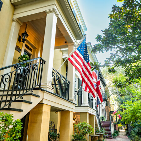 Capture the essence of Southern charm with this stunning print of a yellow house adorned with American and British flags in the heart of Savannah, Georgia. This high-quality print showcases the vibrant exterior of a classic Southern home, complete with lush greenery and a welcoming front porch. Perfect for adding a touch of historical elegance to your home decor, this print is a must-have for lovers of architecture, history, and Southern culture.